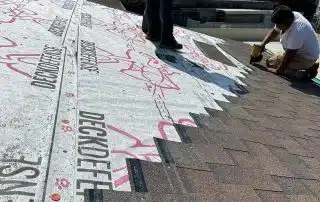 workers putting new shingles on the roof