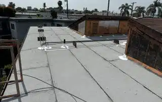 Torch down roof repairs to reinforce and waterproof affected flat roof areas.