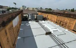 Torch down roof repairs to reinforce and waterproof affected flat roof areas.