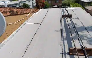 Torch down roof repairs to reinforce and waterproof affected flat roof areas.
