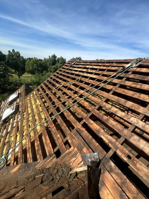 Exposed roof rafters and decking during a structural roof repair