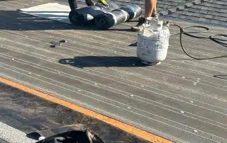Crew safely working on sloped roof during Glendale replacement project