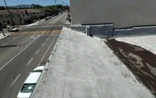 Damaged flat roof membrane removed during Burbank roof project