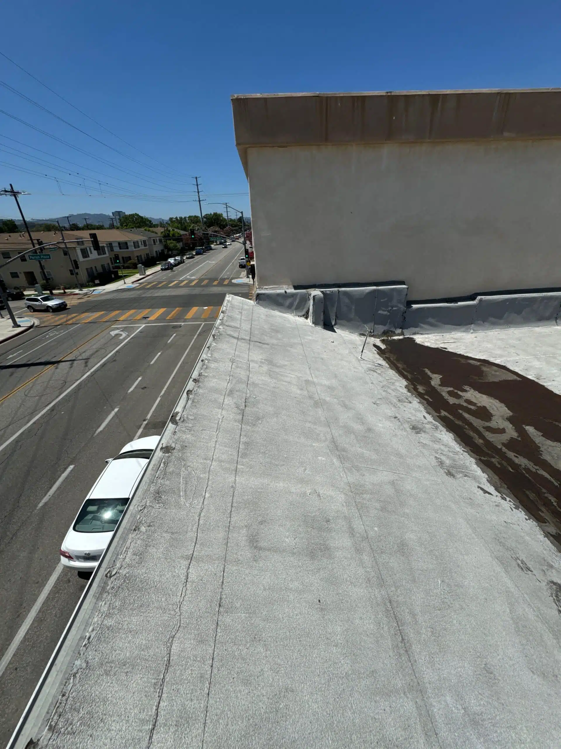 Damaged flat roof membrane removed during Burbank roof project