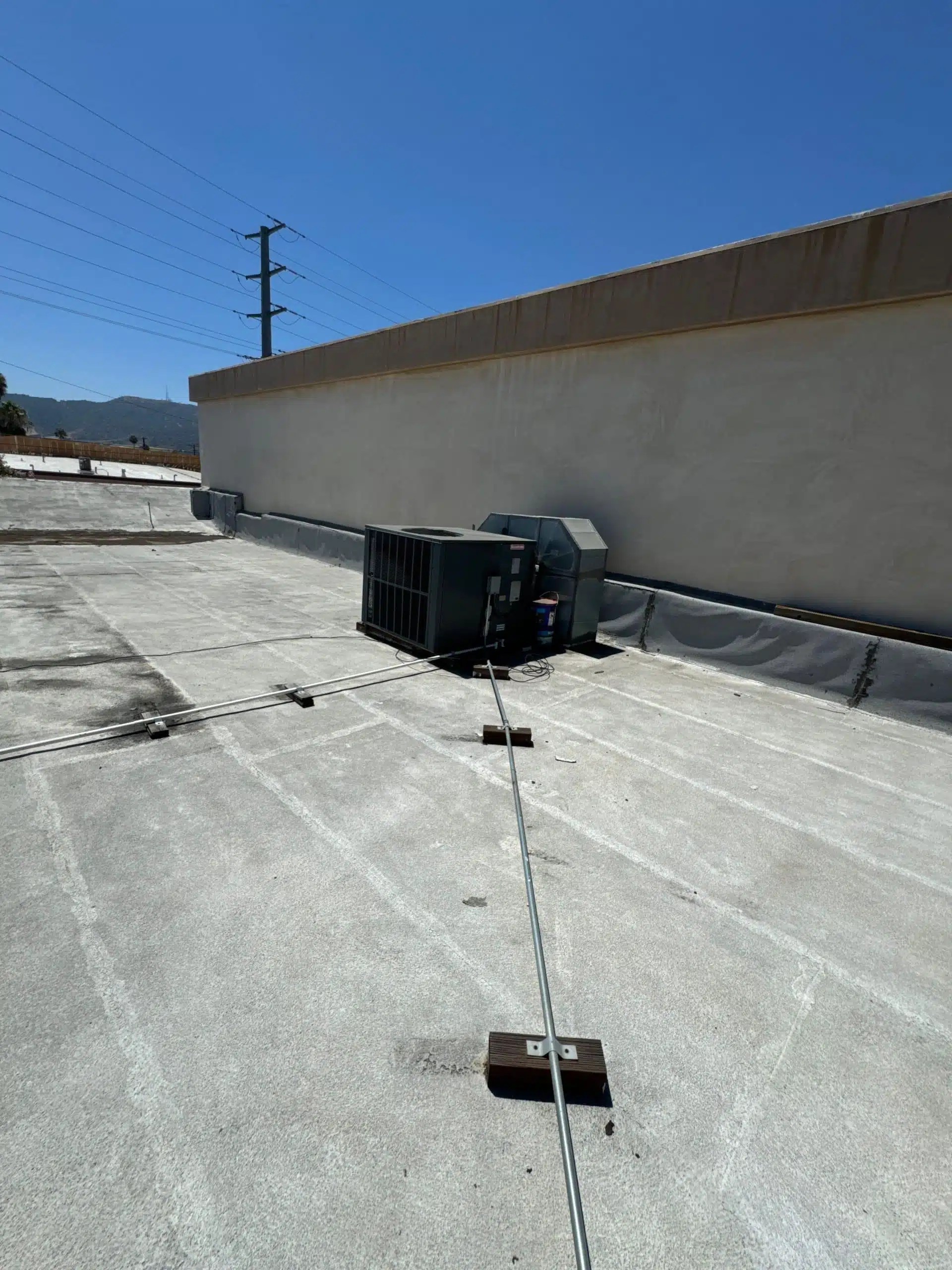 Reinforced flashing along roof edge during Burbank flat roof repair