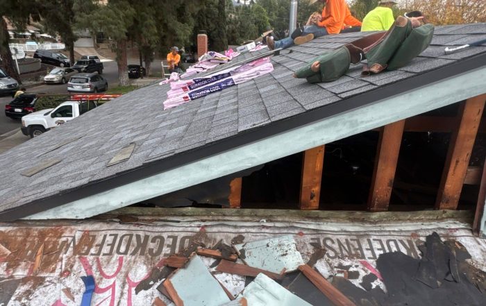 Roof Repairs CA team replacing damaged shingles in Burbank home