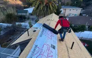 roofer rolling first underlayment down