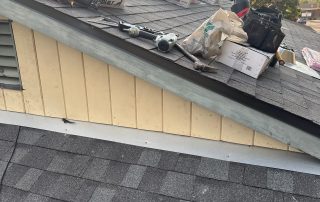 Tools and materials on rooftop, sunset background.