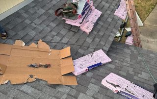 Rooftop with shingles and tools for construction work.