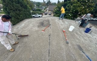 Roofer inspecting torched down roof