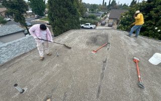 Roofers spreading out the new gravel