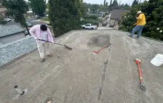 Roofers spreading out the new gravel
