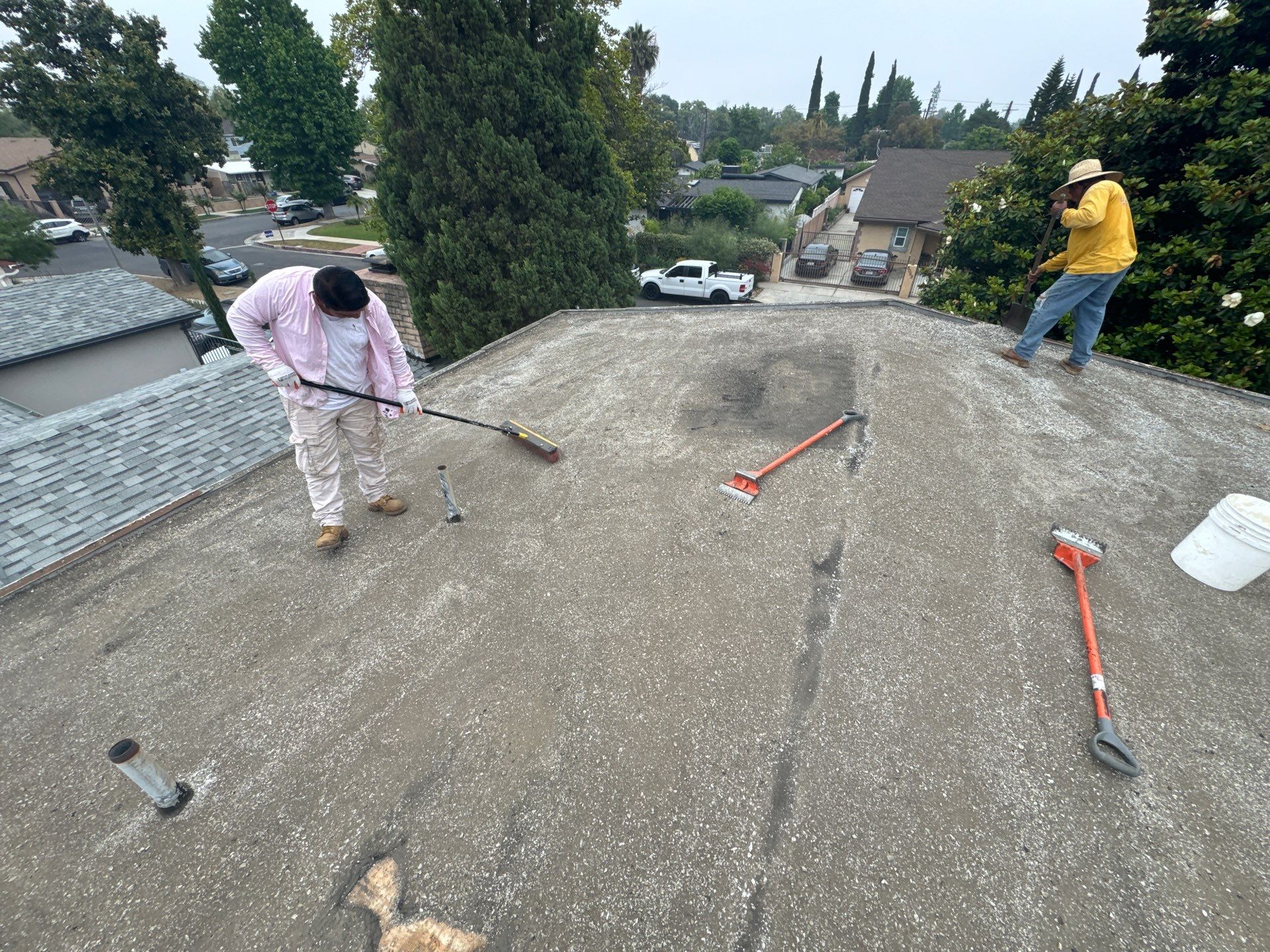 Roofers spreading out the new gravel