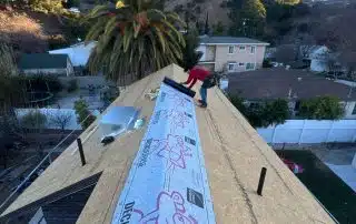 roofer rolling underlaymnet