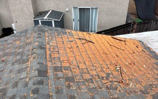 House roof with debris and visible damage.