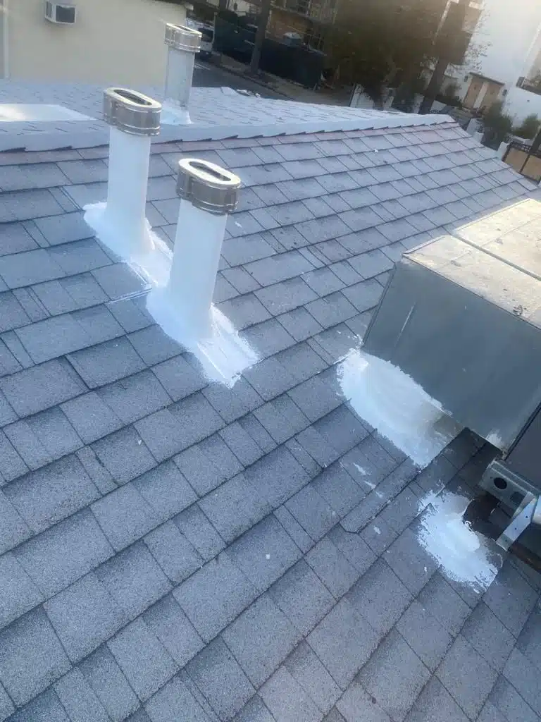 Waterproof membrane being applied over reinforced roof flashing Waterproof membrane being applied over reinforced roof flashing