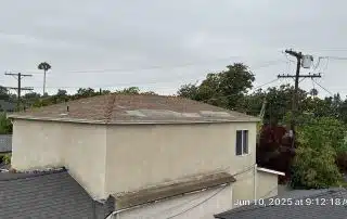 Overcast sky view above neighborhood rooftops.
