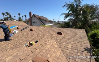 10-Jun 09 2025 03_02pm-LH2N Roofer working on shingled roof under clear sky.