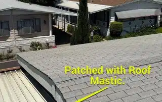 Roof patched with mastic in a residential area.