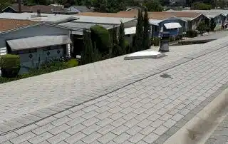 Residential neighborhood with rooftops and trees.