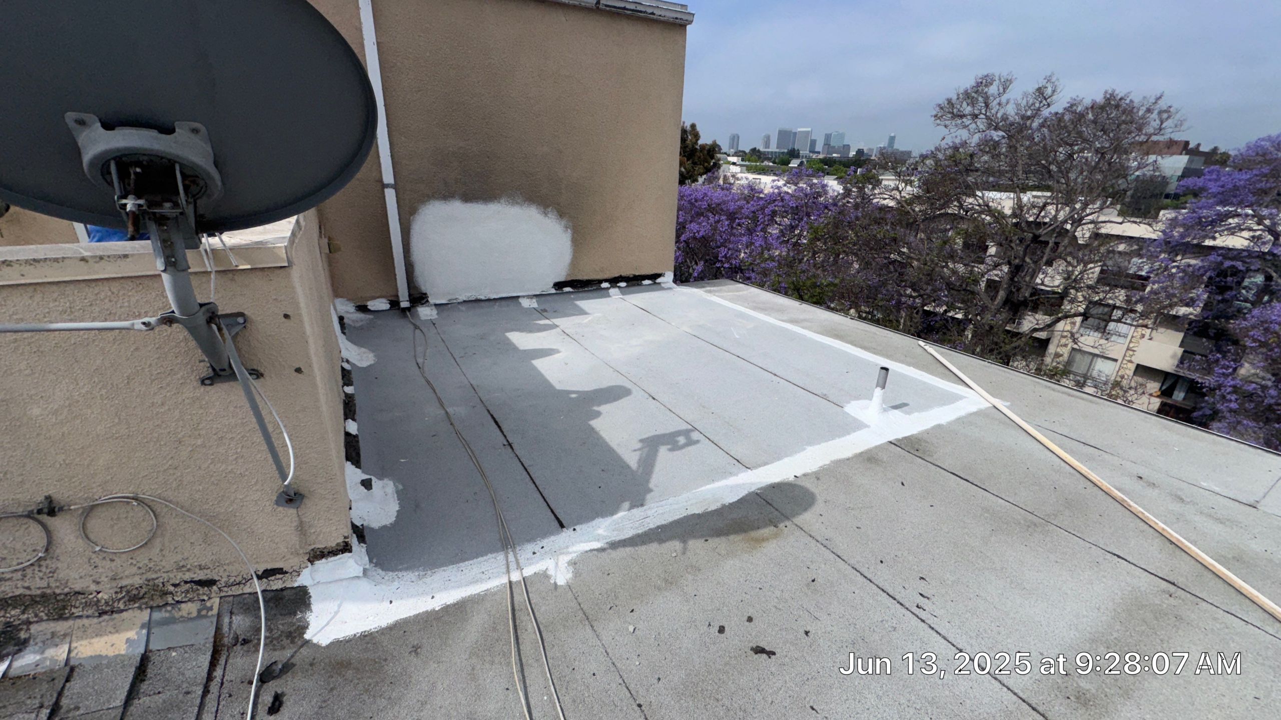 Rooftop with satellite dish and cityscape background