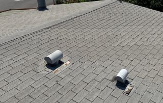 Rooftop view with trees and buildings in background