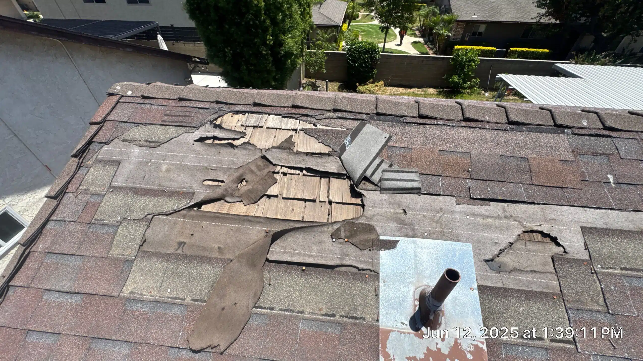 16-Jun 12 2025 01_39pm-JuiZ Damaged roof with missing shingles and holes.