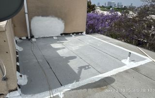 Rooftop with repaired areas and city view.