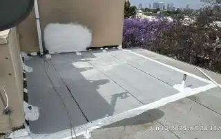 Rooftop with repaired areas and city view.