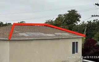 Damaged roof with missing shingles highlighted in red.