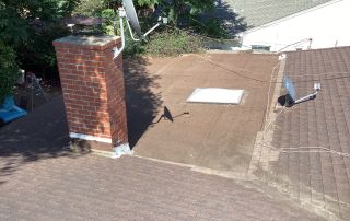 House rooftop with chimney and satellite dish.
