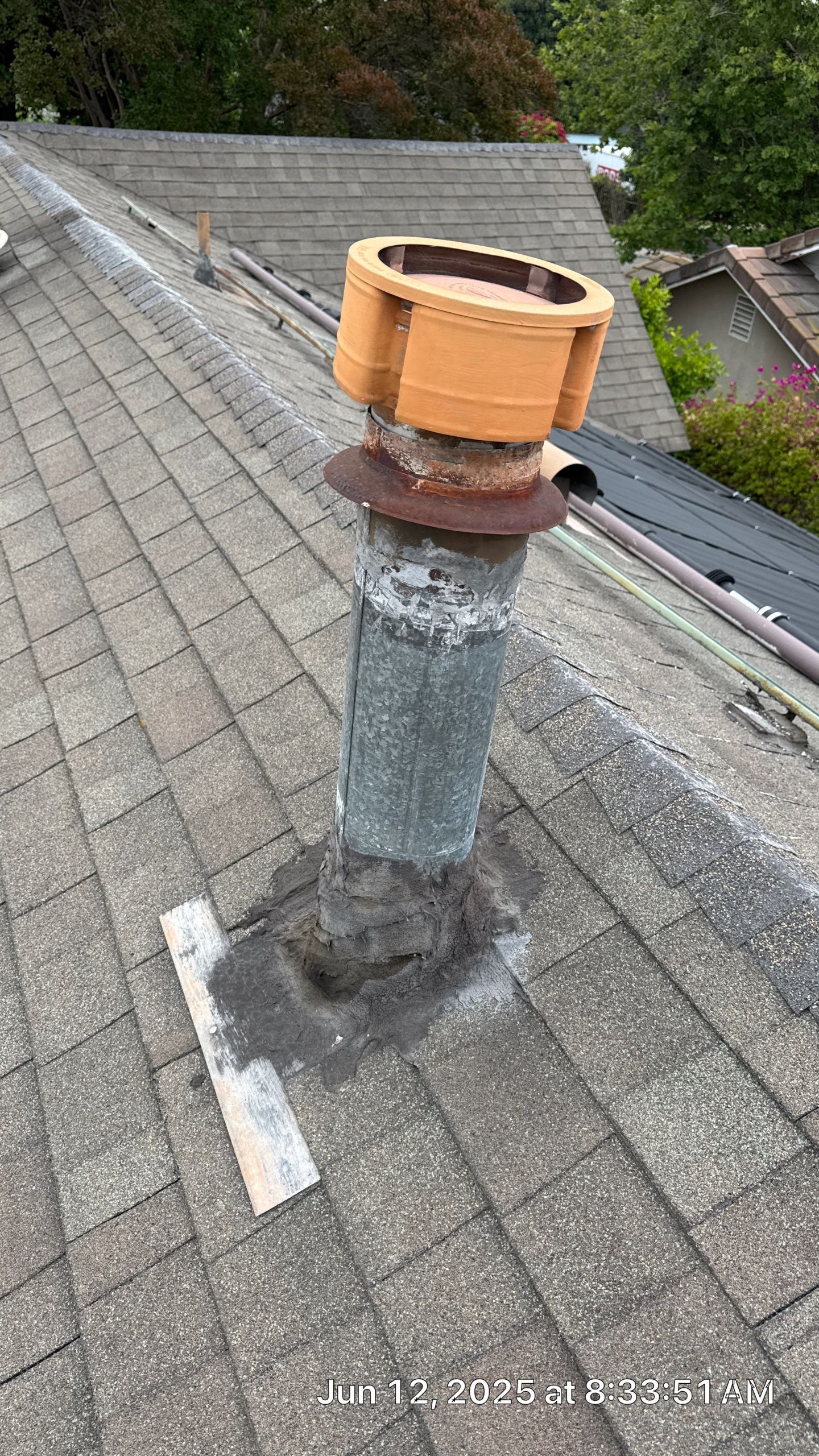 26-Jun 12 2025 08_33am-qLU1 Roof vent with wood cover on shingles.