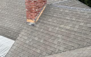 Roof with brick chimney and shingles