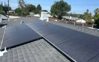 31-Jun 26 2025 10_56am-WaZr Solar panels on suburban rooftop under clear sky.