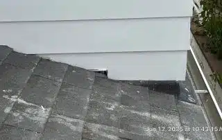 33-Jun 12 2025 10_43am-GauF Close-up of rooftop shingles meeting white siding.