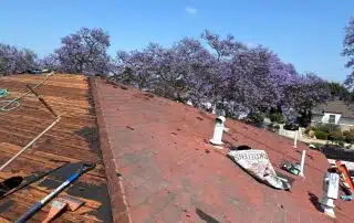 Roof renovation with tools and shingles.