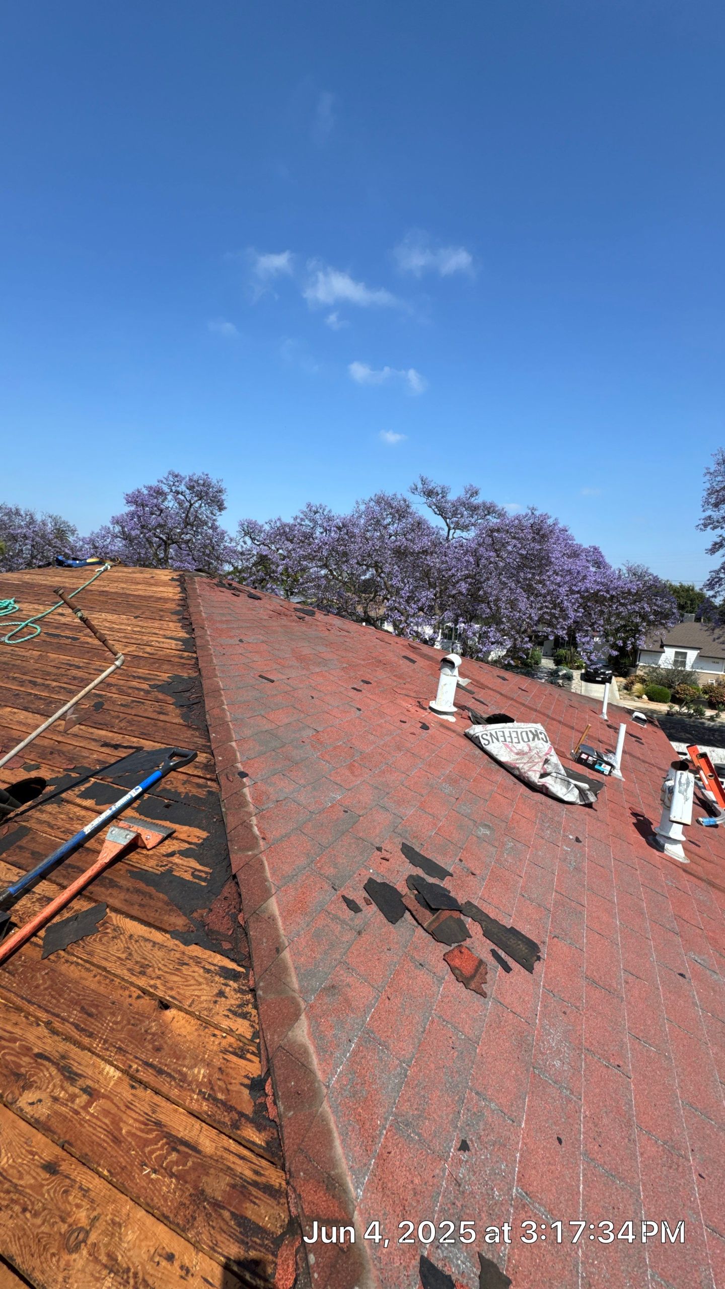 Roof renovation with tools and shingles.