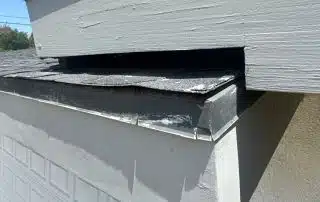4-Jun 26 2025 10_54am-jvws Garage roof and brick wall detail on sunny day.