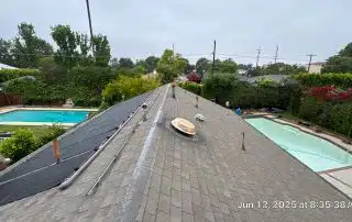 41-Jun 12 2025 08_35am-dH9D Rooftop solar panels near swimming pools, outdoor view.