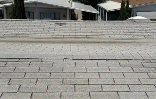 Residential rooftops under clear blue sky