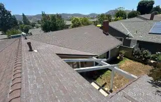 43-Jun 12 2025 01_40pm-BBso Residential rooftops with solar panels and distant mountains.