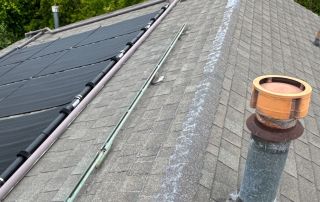 Rooftop with solar panels and chimney.