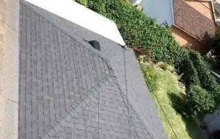 Aerial view of residential rooftops and gardens.