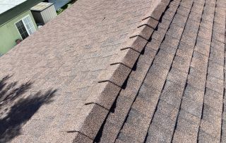 Brown shingle roof under sunlight.