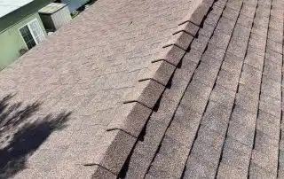 Brown shingle roof under sunlight.