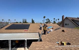9-Jun 09 2025 03_02pm-E4db Workers installing solar panels on a rooftop.