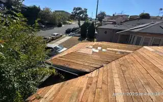 Wooden roof under construction in suburban neighborhood.