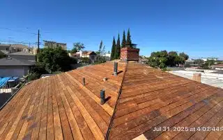 Wooden roof repair under blue sky
