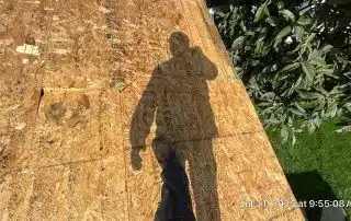 Shadow of person on wooden roof deck