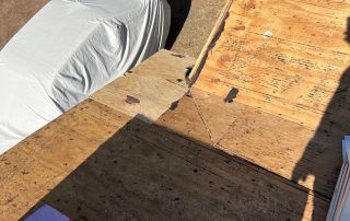 Rooftop construction area with visible tarpaper.